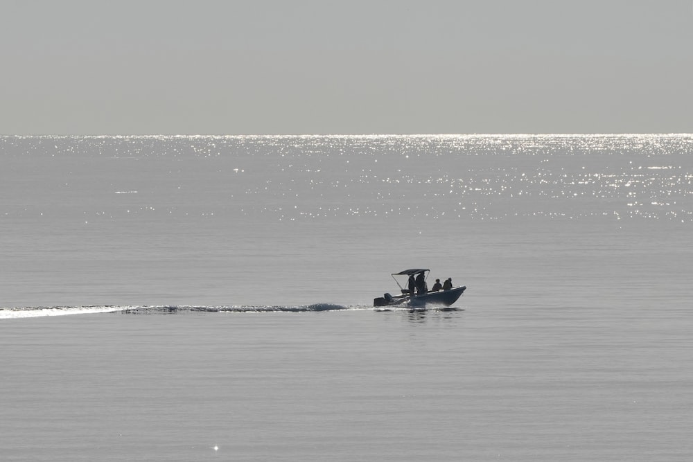 a small boat in the middle of a large body of water