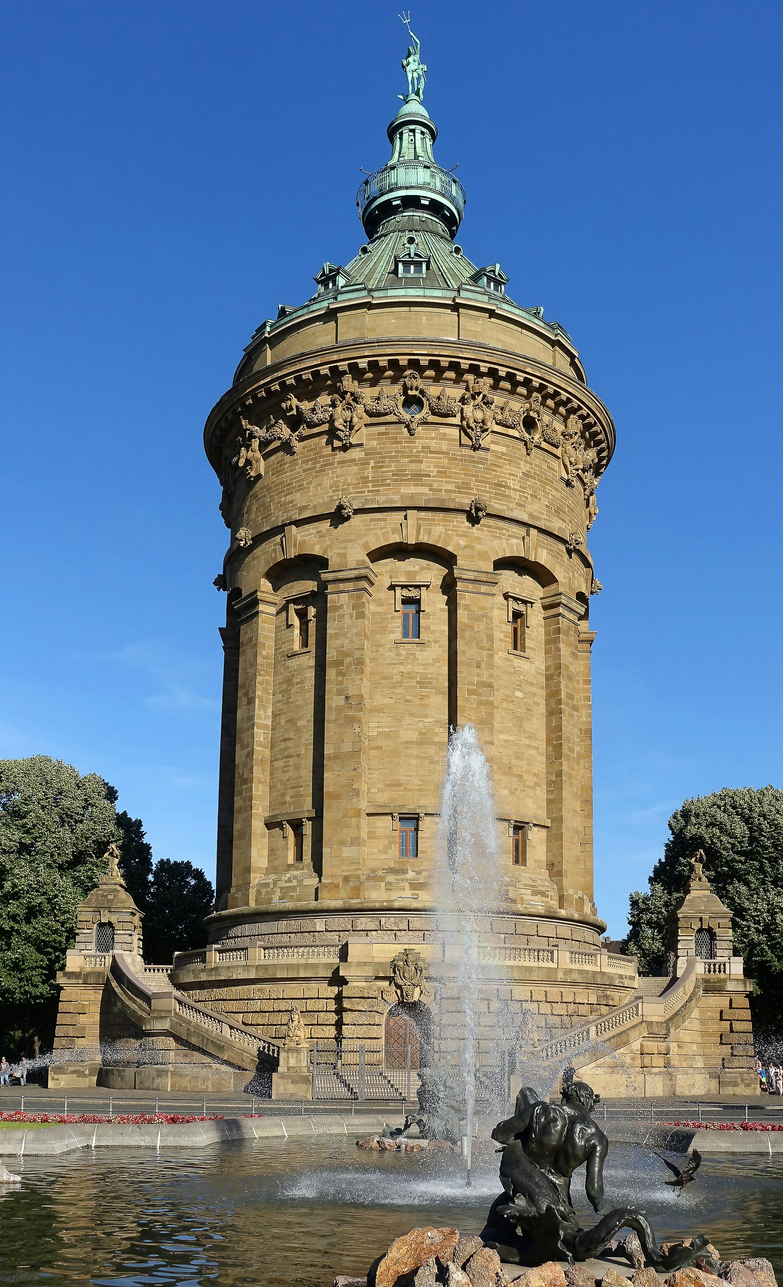 a water fountain in front of a large building