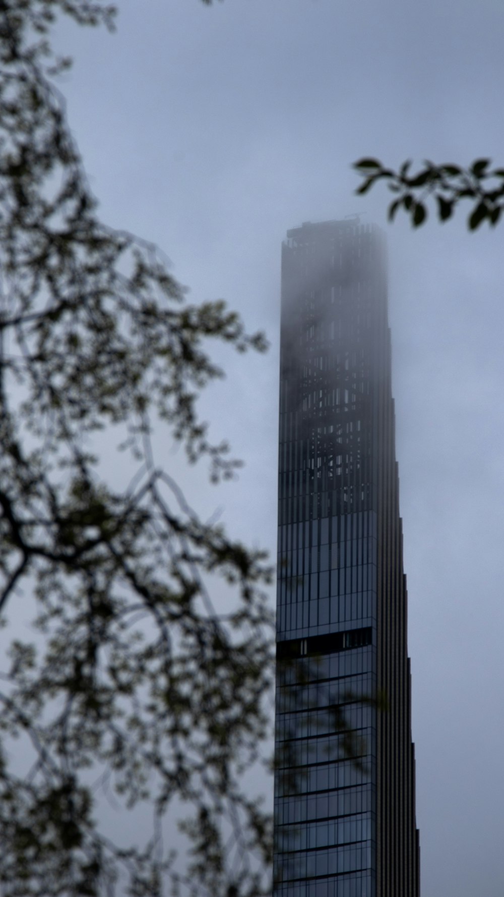 a very tall building with a very foggy sky behind it