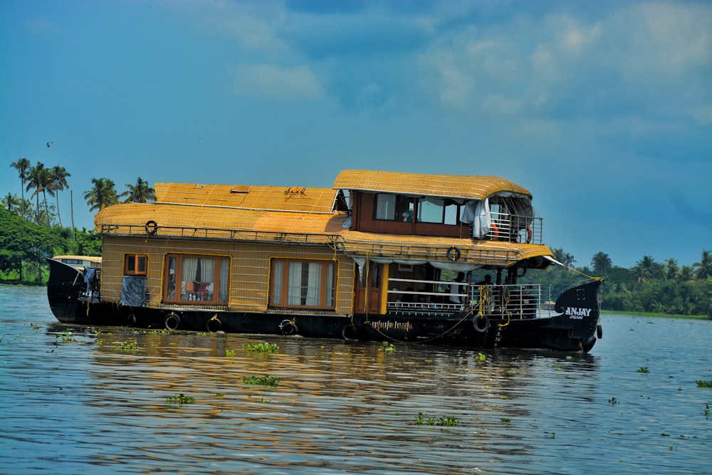 a house boat floating on top of a body of water