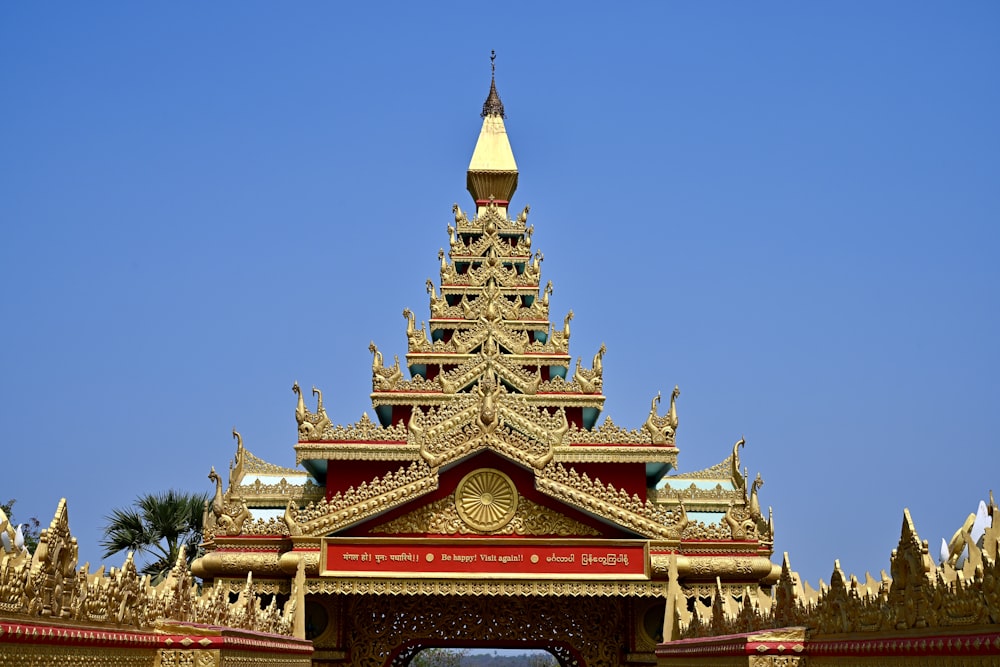 a large golden building with a clock on top of it