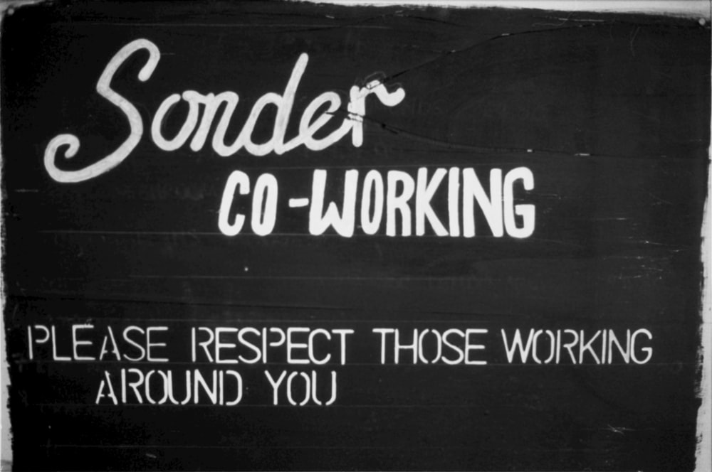 a black and white sign that says, soder co - working please respect those