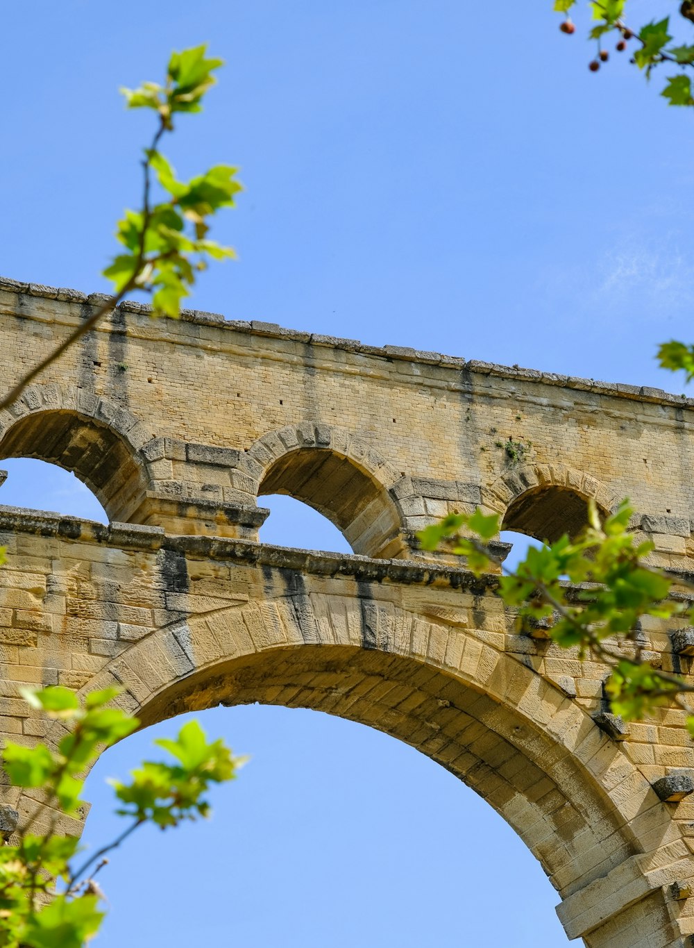 an old stone bridge with arched arches and a blue sky in the background