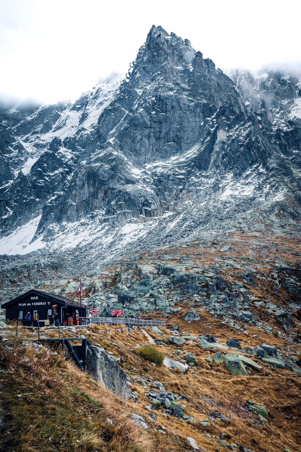 a mountain covered in snow next to a building