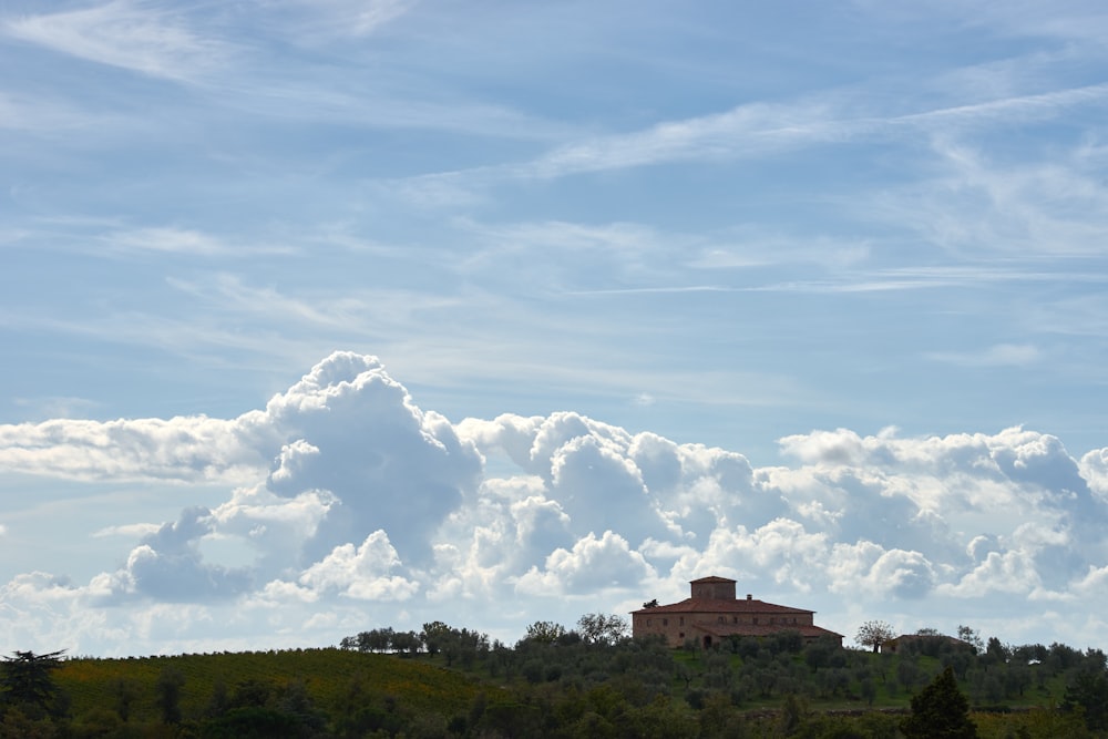 a building on a hill with a sky background