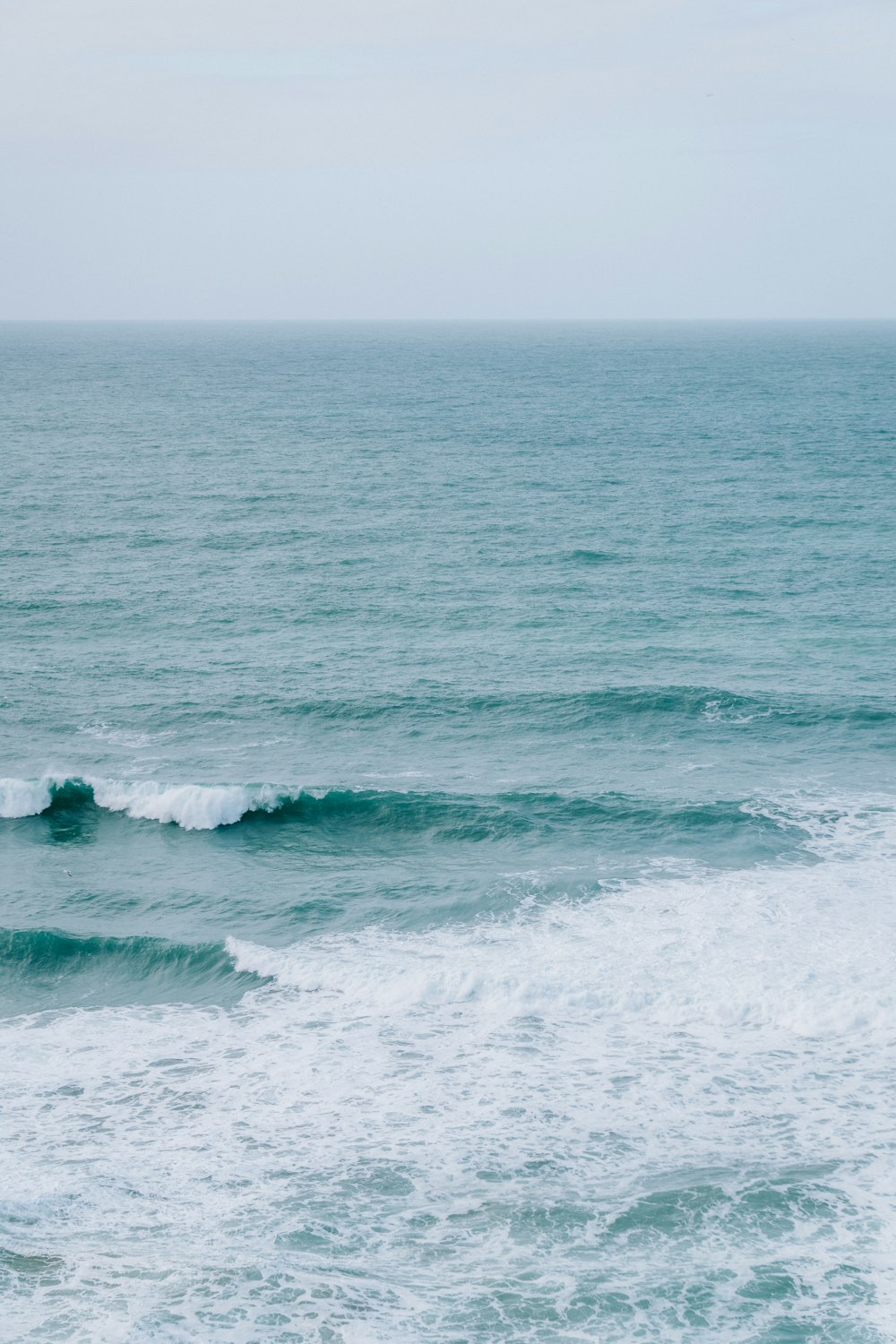 a person riding a surfboard on a wave in the ocean