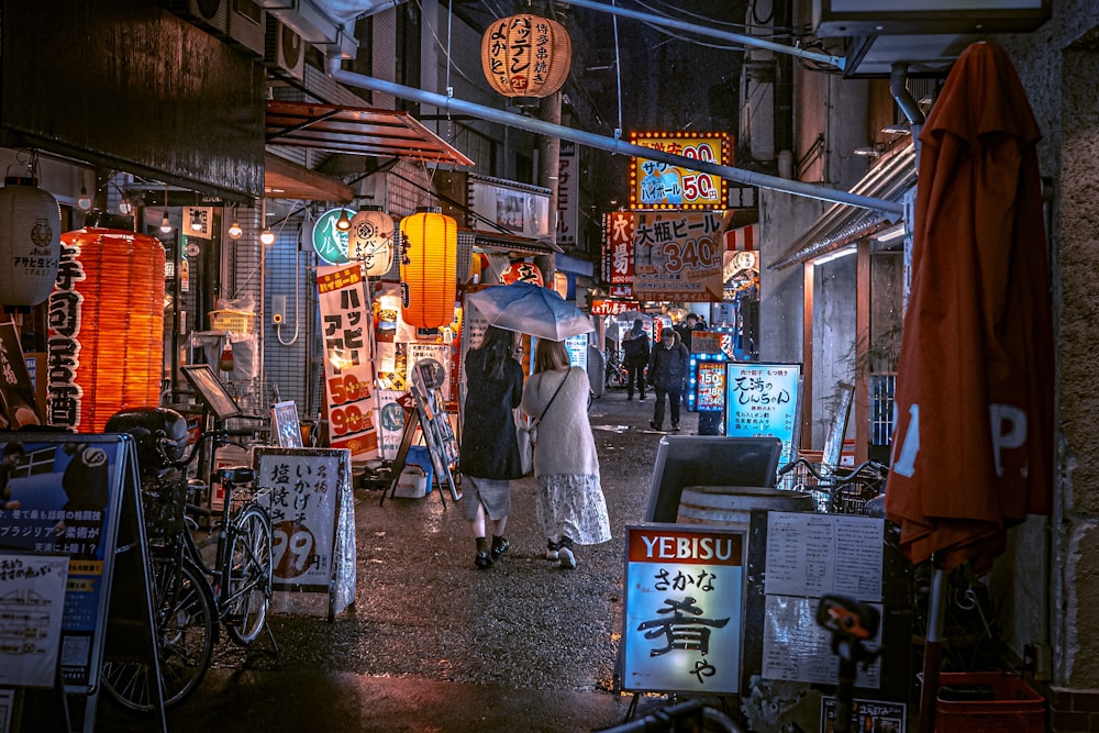 a woman walking down a street holding an umbrella