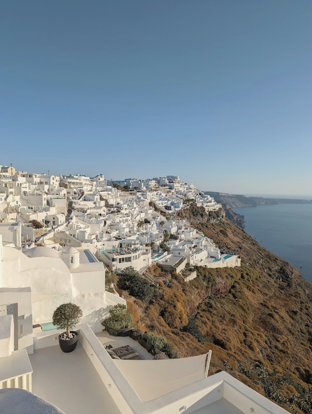 a view of a white village from a hill