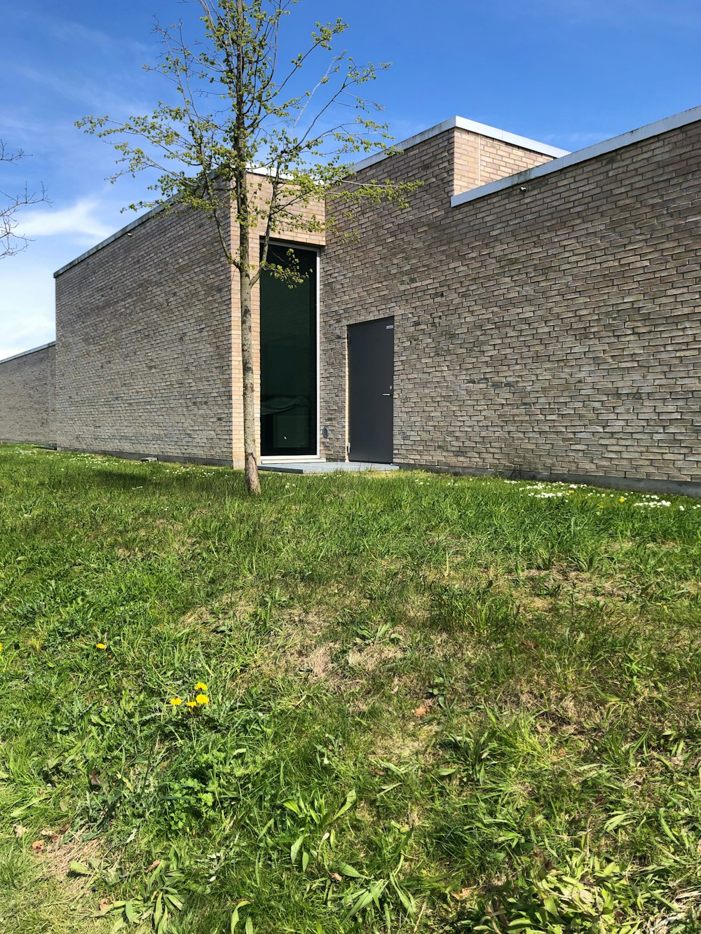 a brick building with a tree in front of it