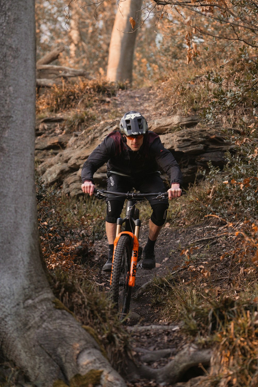 a man riding a bike down a dirt trail