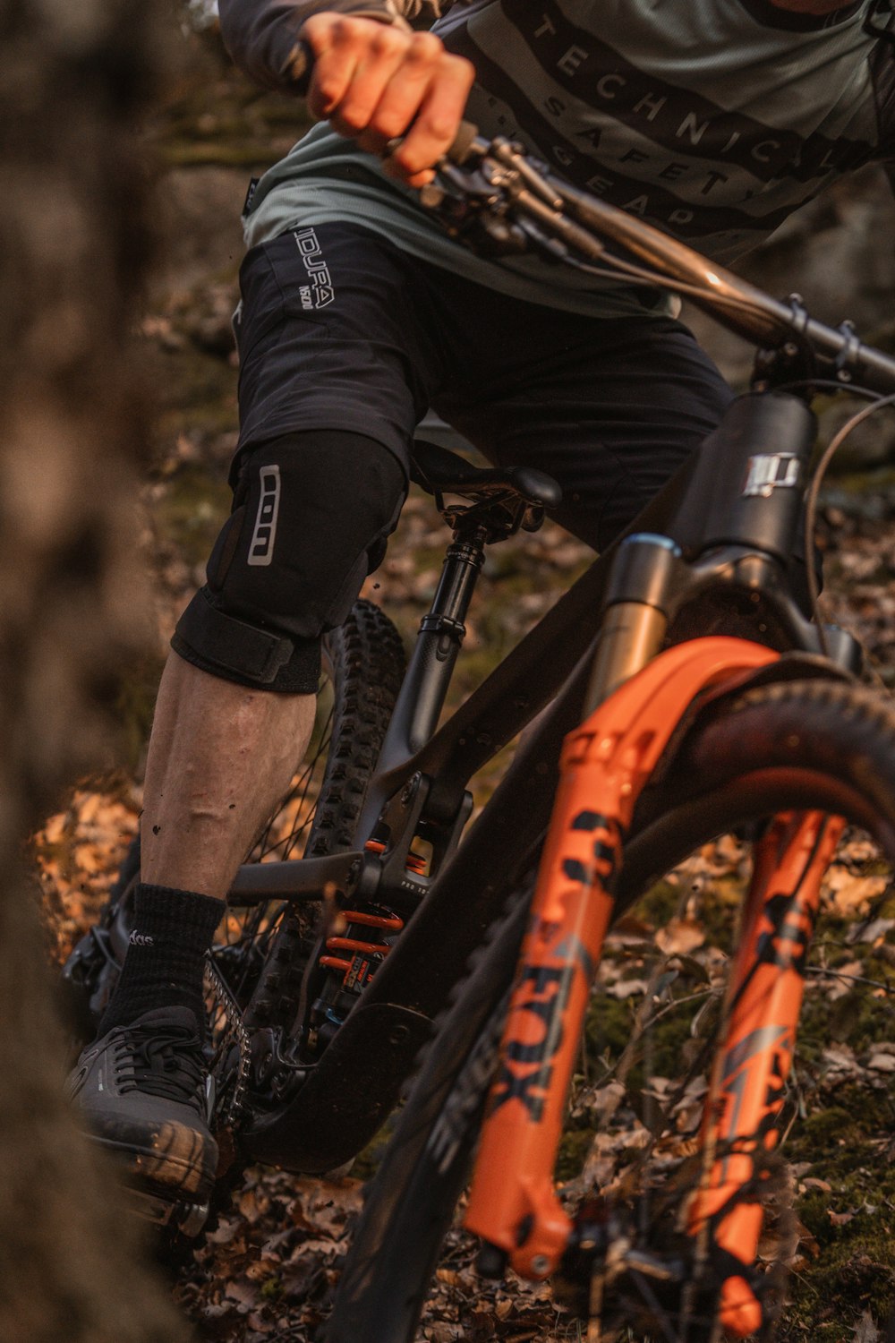 a man riding a mountain bike through a forest