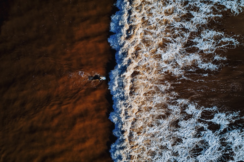 a person riding a surfboard on top of a body of water