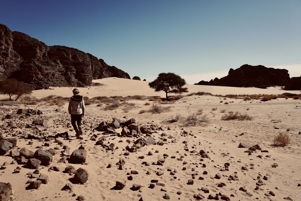 a man standing in the middle of a desert