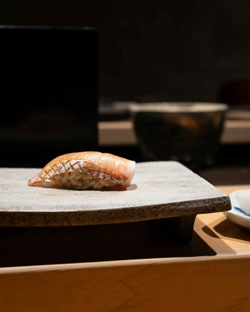 a piece of sushi sitting on top of a table