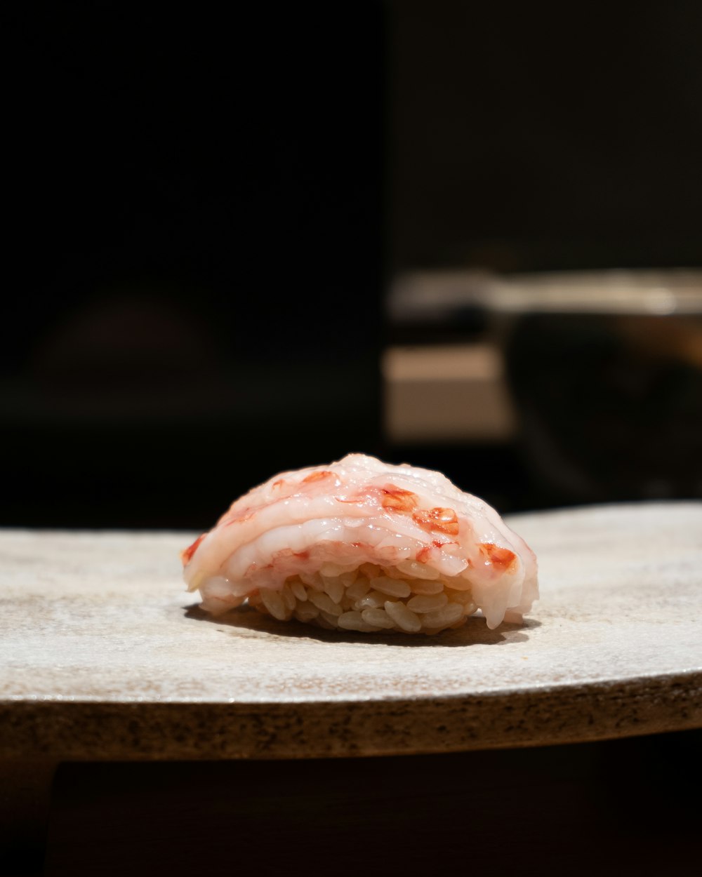 a piece of sushi sitting on top of a table