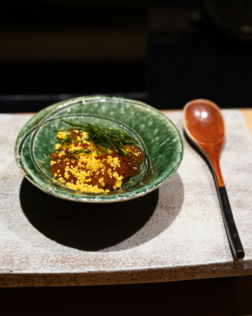 a bowl of food on a table with a spoon