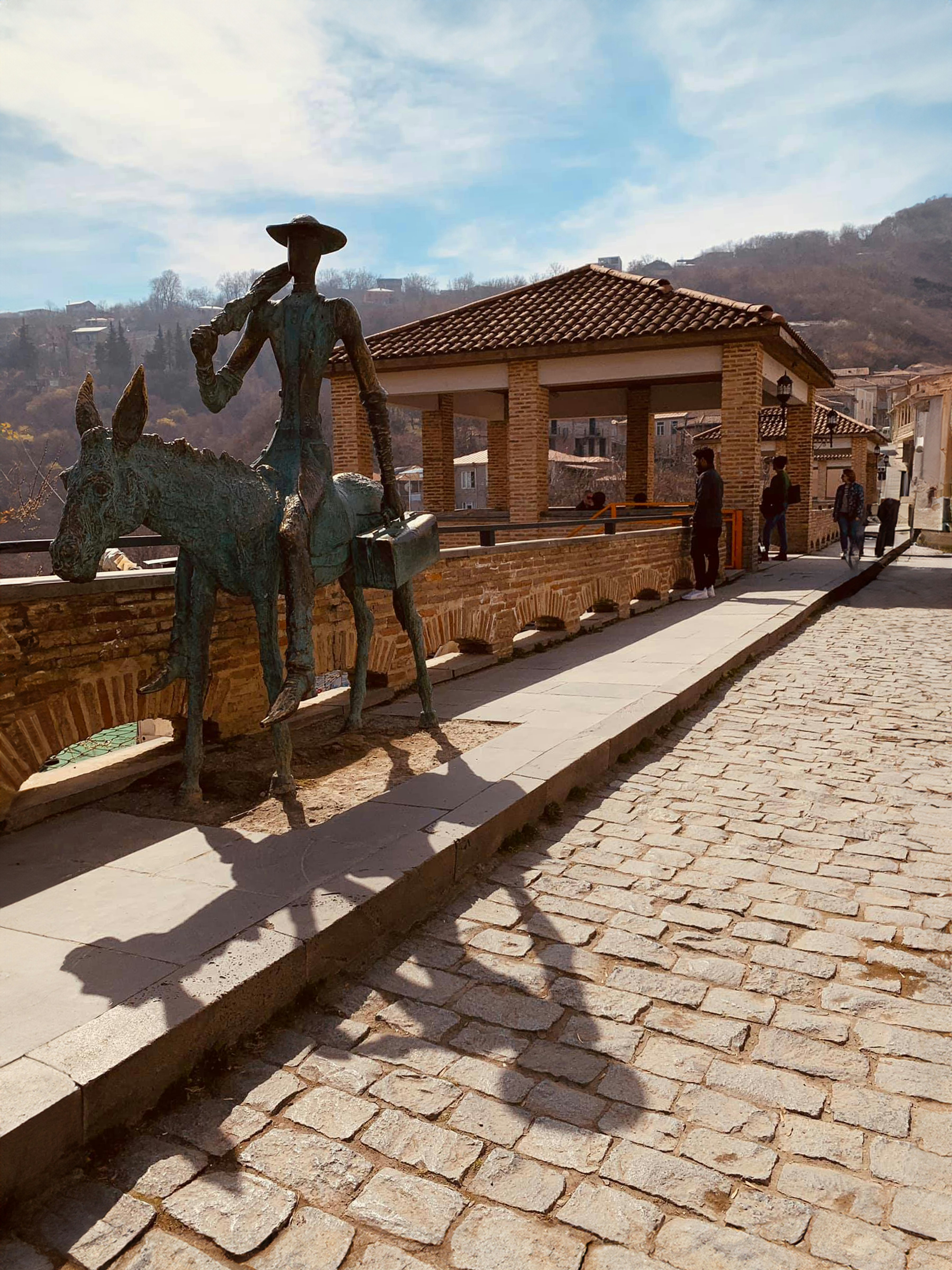 a statue of a man riding a horse next to a building