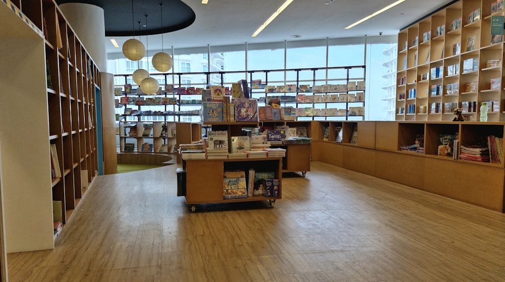 a library filled with lots of books next to a window