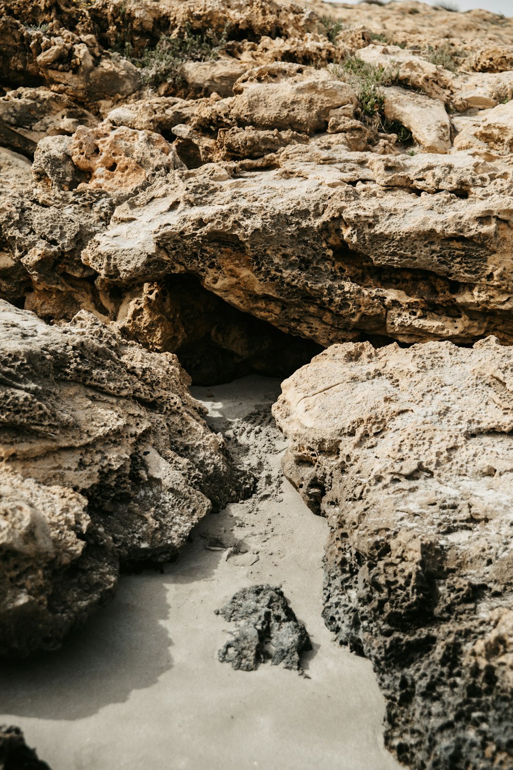 a close up of rocks and sand on a beach