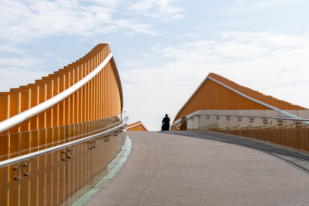 a man standing on a walkway next to a building