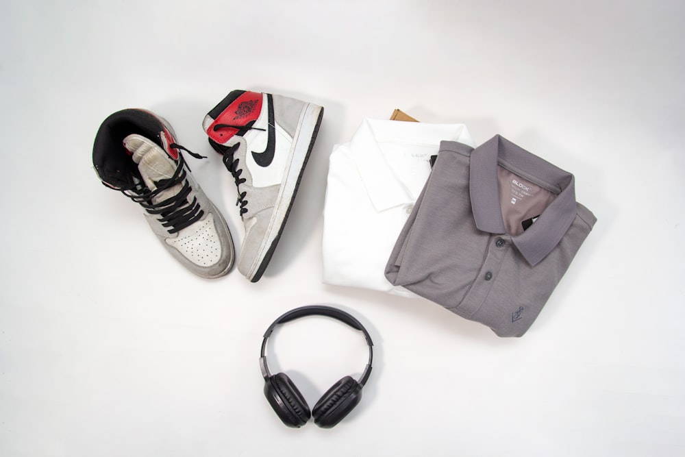 a pair of headphones sitting next to a pair of sneakers