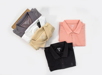 four different colors of polo shirts on a white background