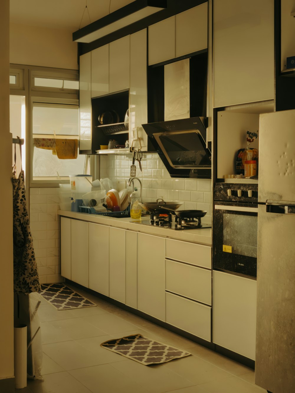 a kitchen with white cabinets and black appliances