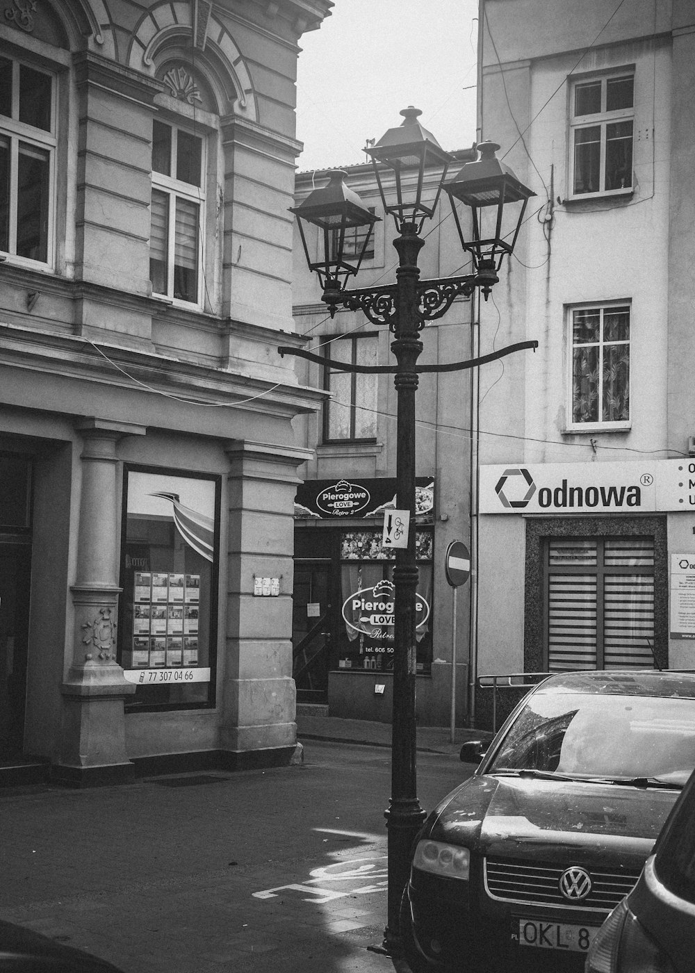 a black and white photo of a street light