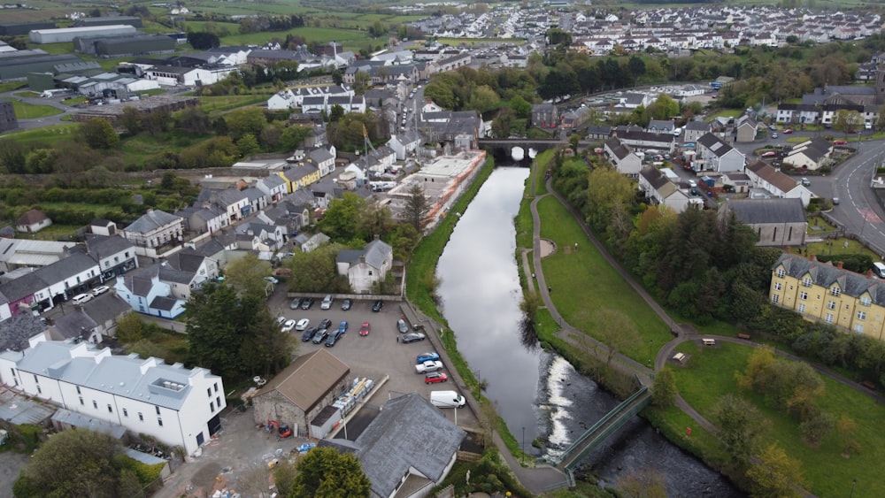 an aerial view of a river running through a small town