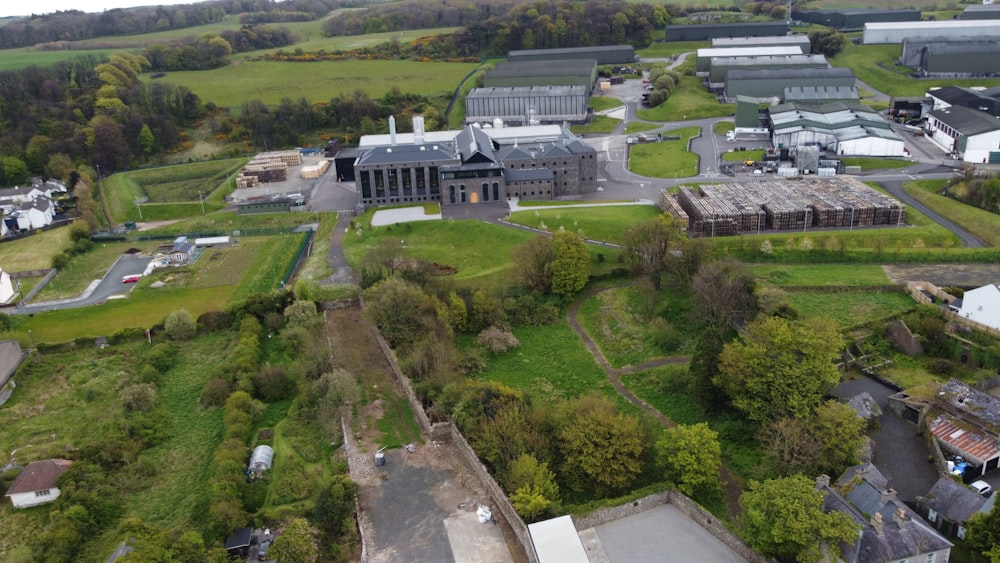 an aerial view of a large building surrounded by trees