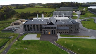 an aerial view of a large building in the middle of a field