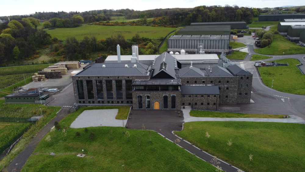 an aerial view of a large building in the middle of a field