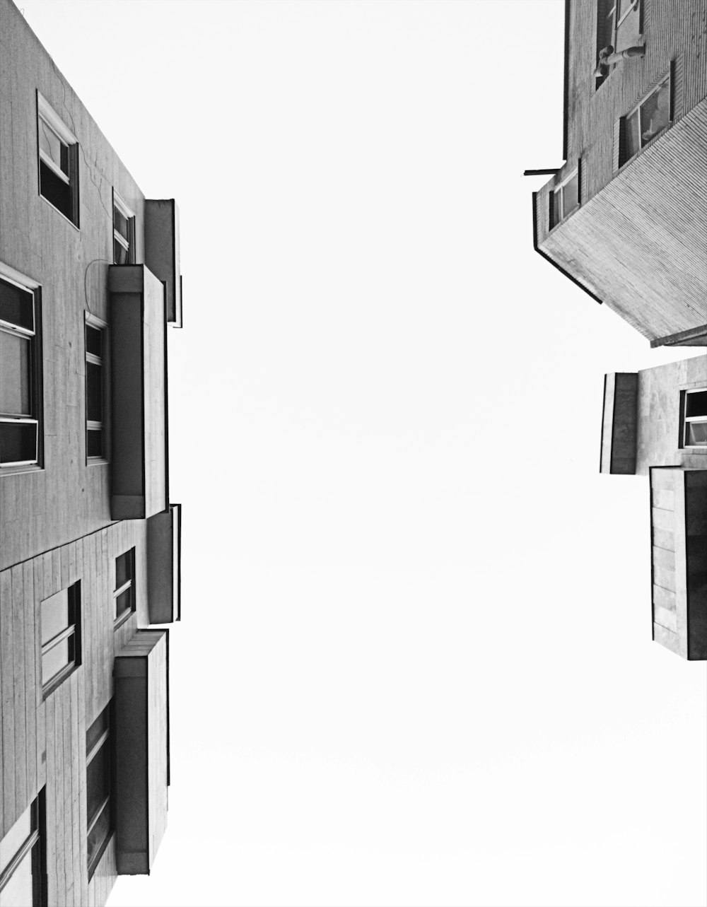 a black and white photo of two tall buildings