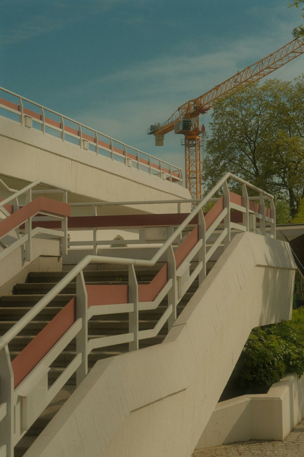 a bridge with a crane in the background