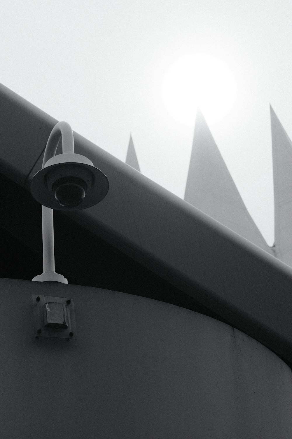 a black and white photo of a security camera