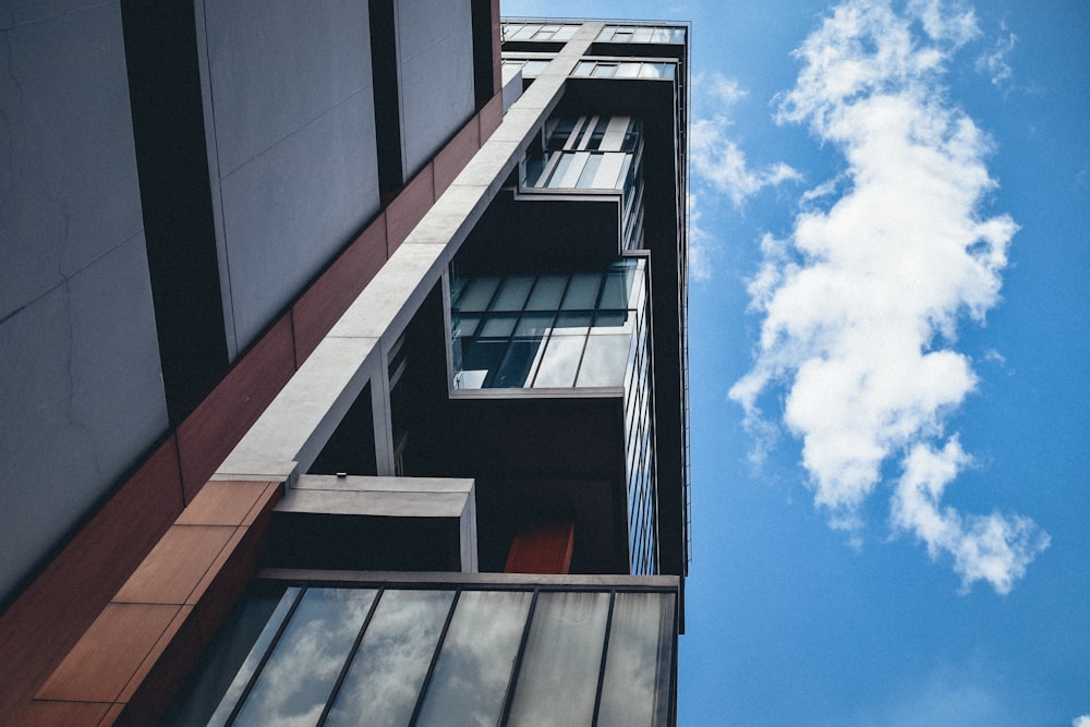 a tall building with windows and a sky background