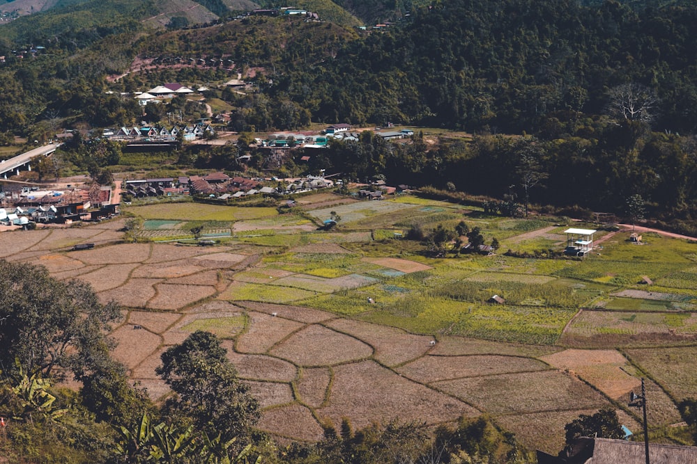 an aerial view of a village surrounded by mountains