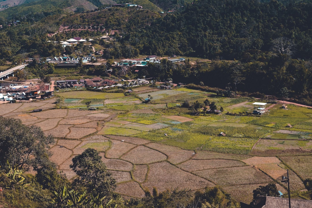 an aerial view of a village surrounded by mountains,