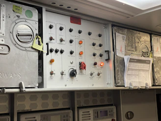 the control panel of an airplane with many buttons