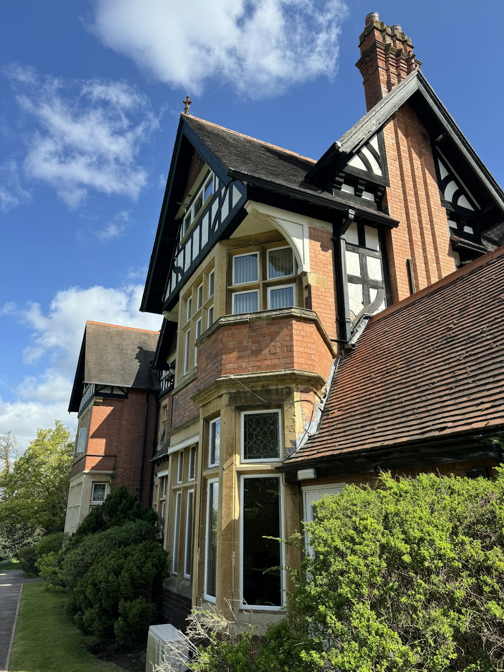 a large brown house with a clock tower