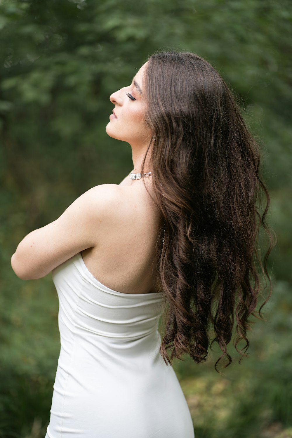 a woman in a white dress is posing for a picture