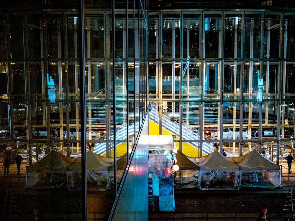 a view of a train station at night from the top of a building