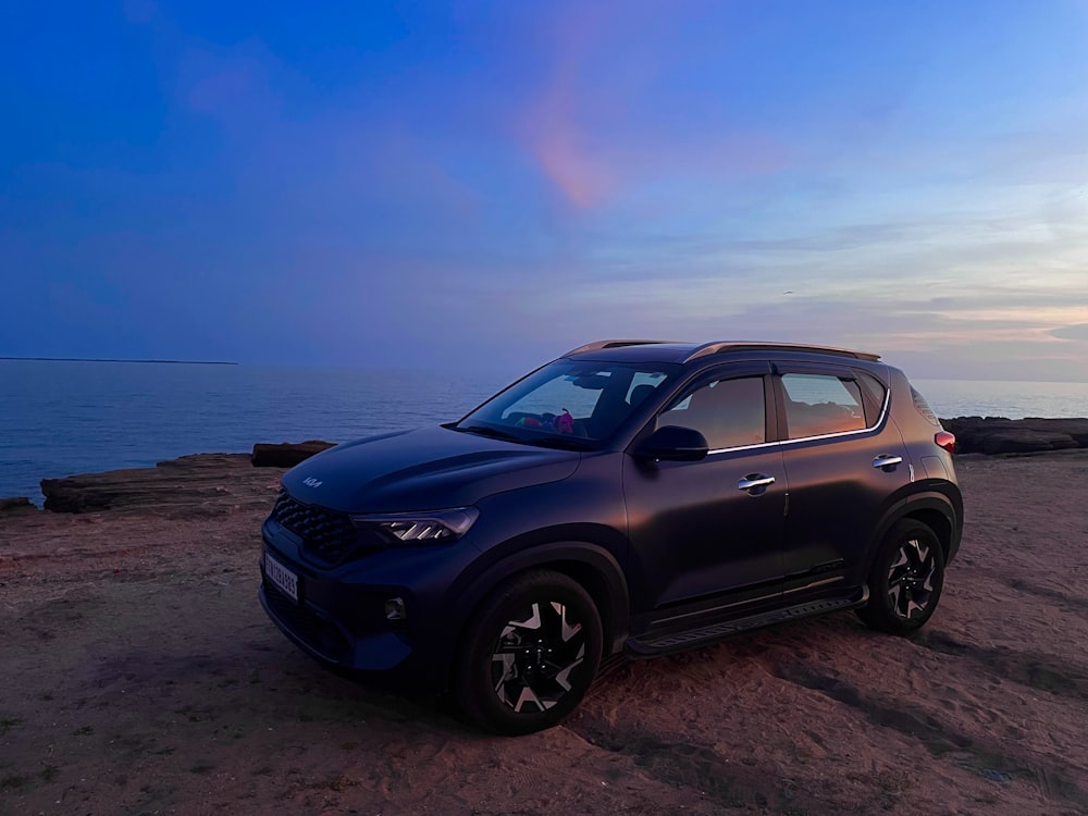 a car parked on a beach near the ocean