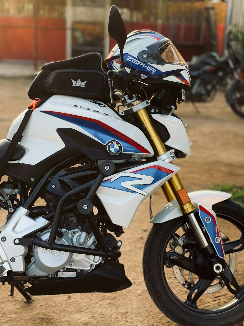 a white motorcycle parked on a dirt road