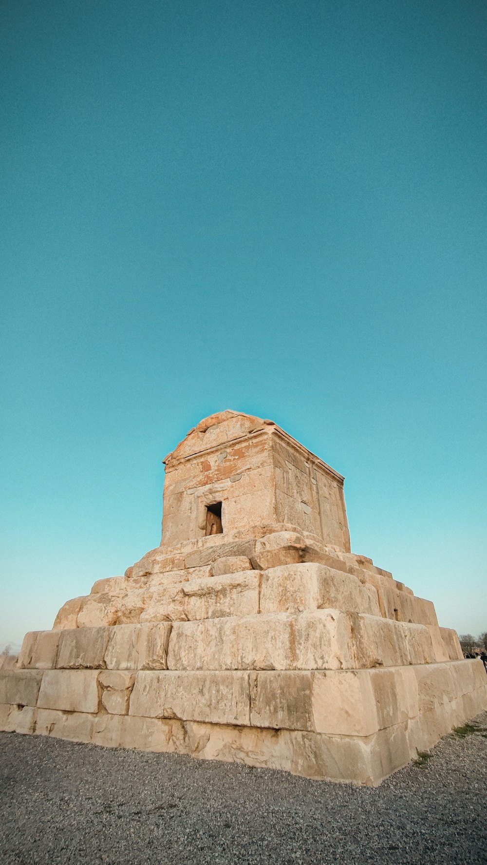 a large stone structure sitting in the middle of a field