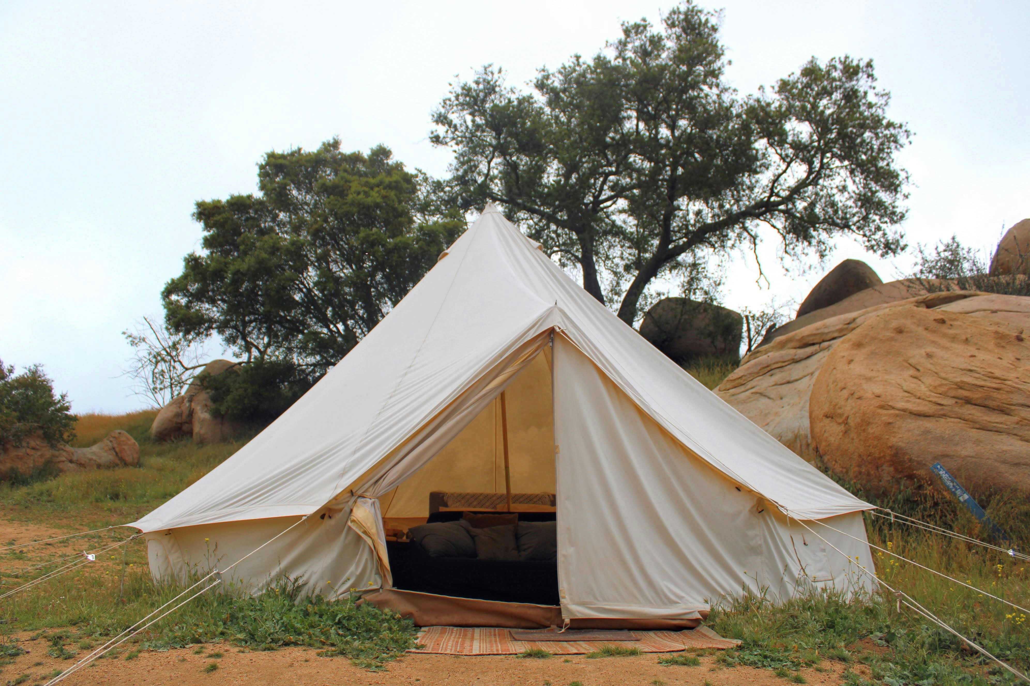 a white tent sitting on top of a lush green field