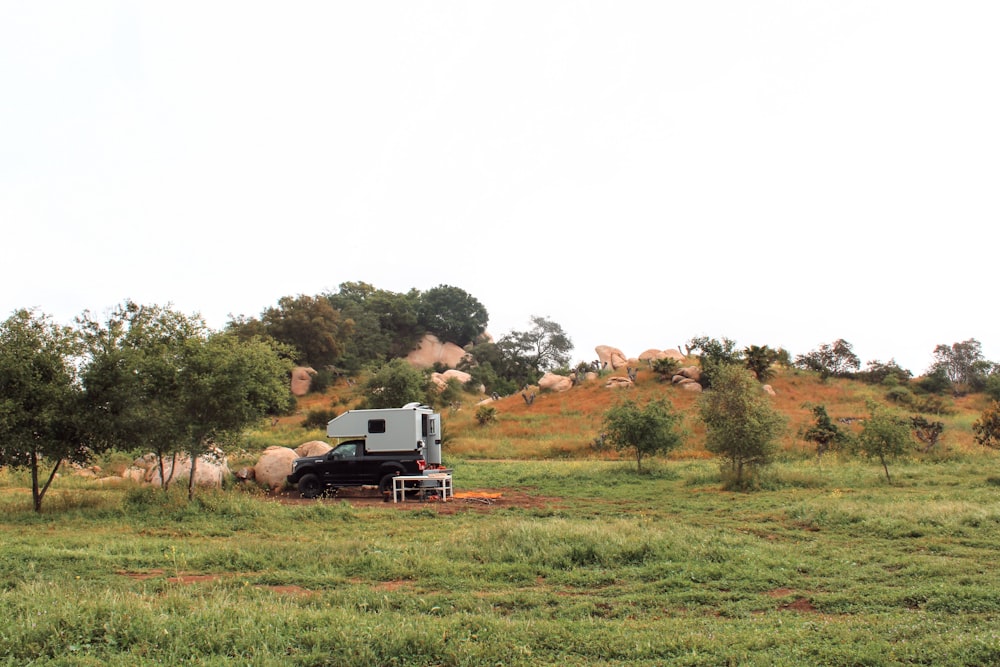 a truck is parked in the middle of a field