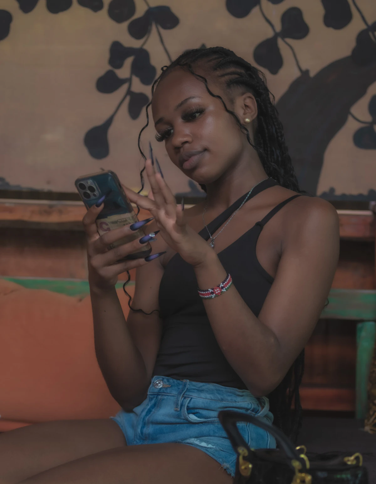 A woman sitting on a couch looking at her cell phone