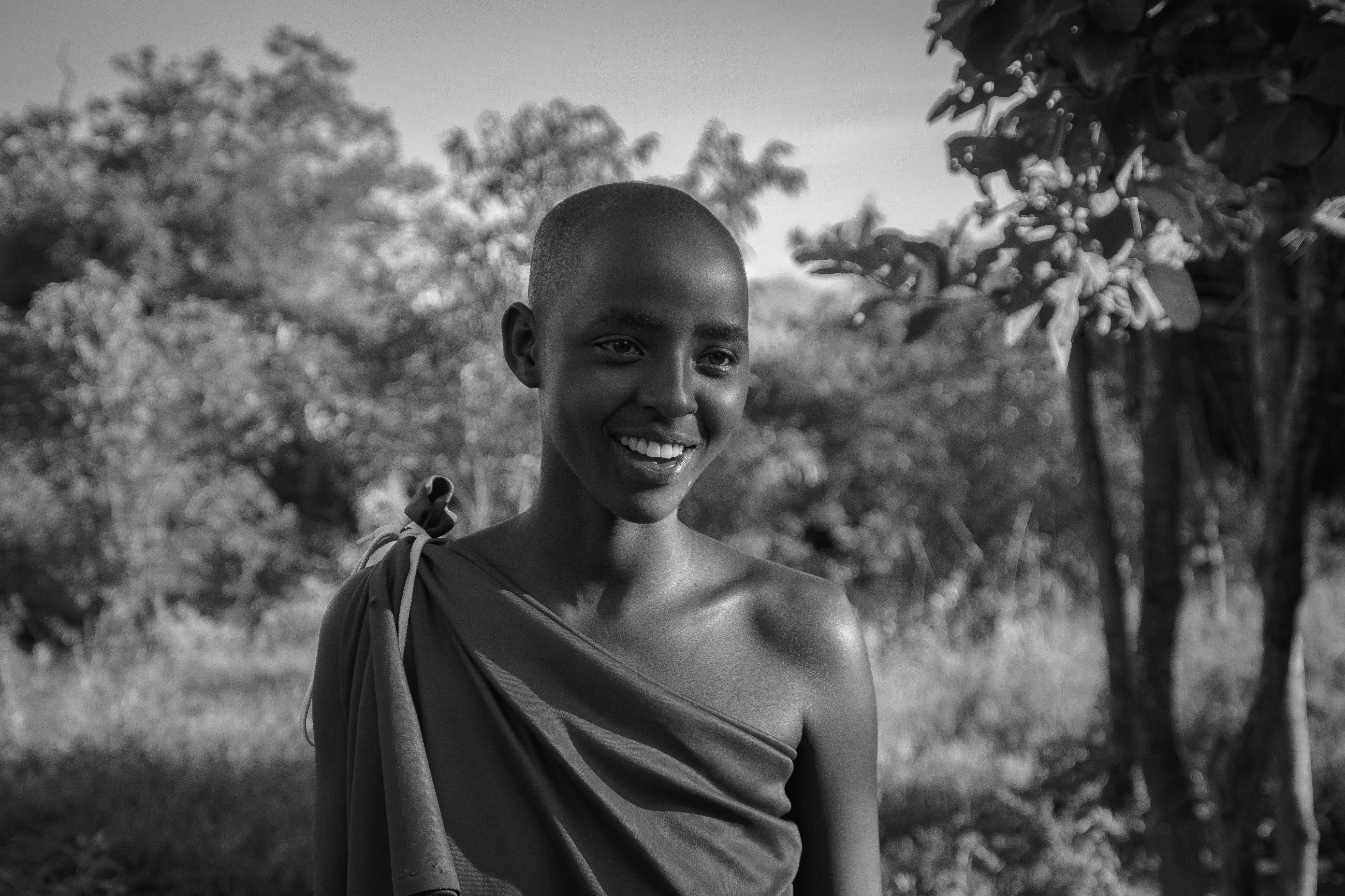 a black and white photo of a smiling man