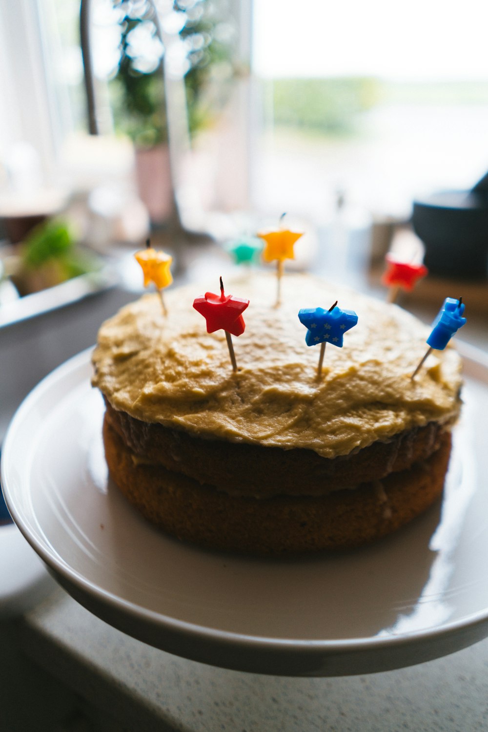 a white plate topped with a cake covered in frosting